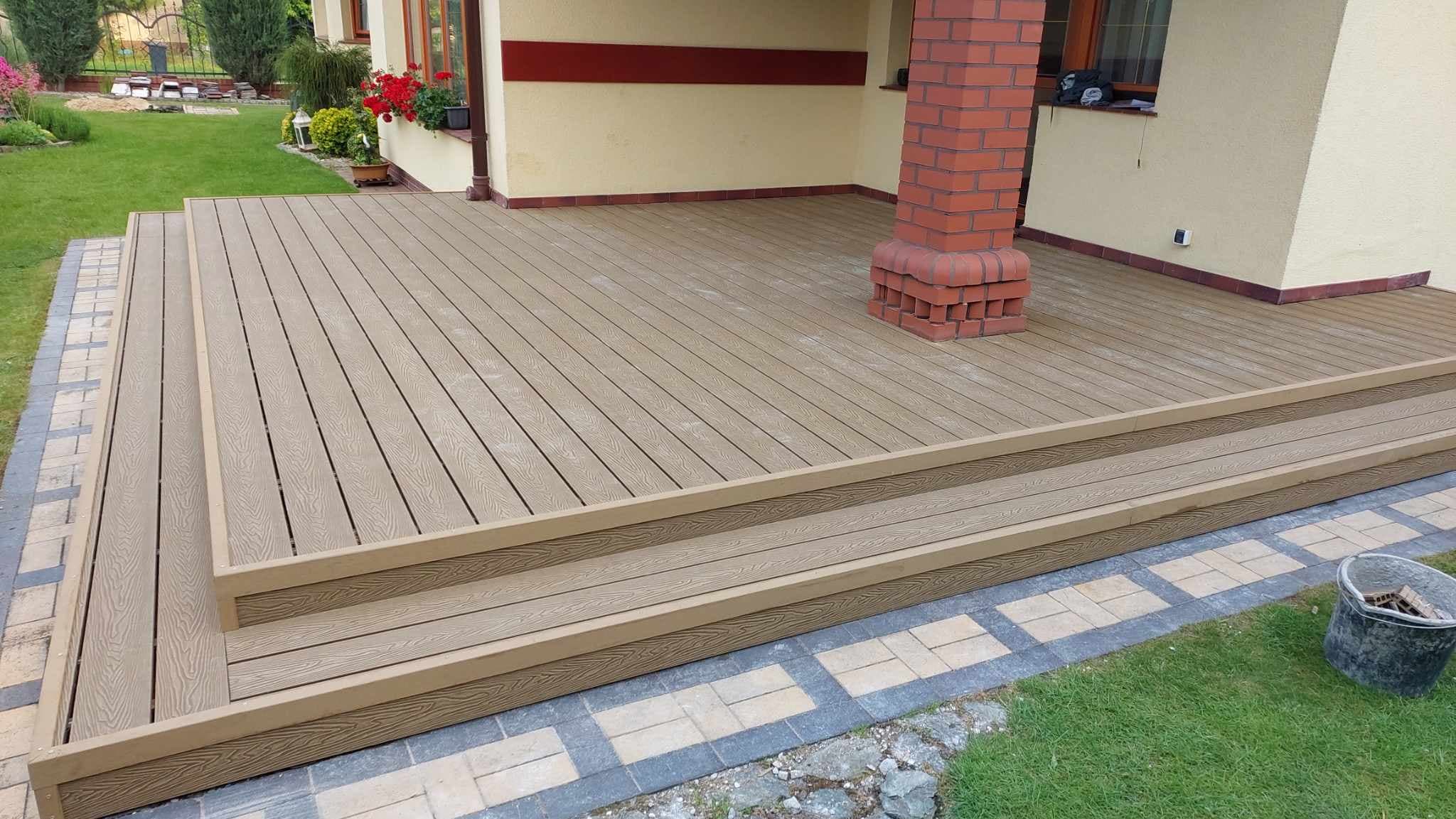 Two-level terrace with composite decking boards featuring an embossed wood grain texture