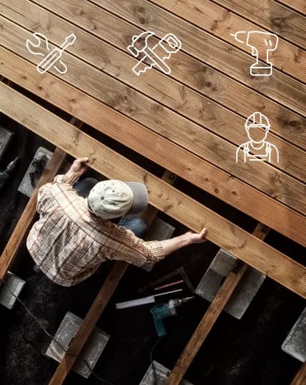Installer laying decking boards on composite joists