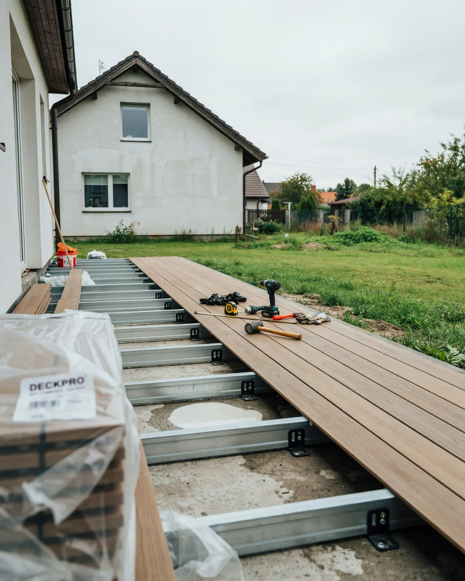 installing a composite decking board using screws and fixing clips