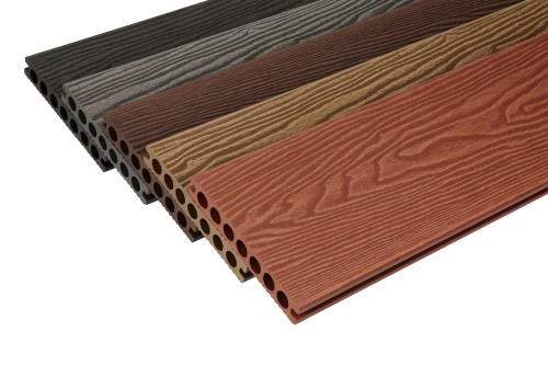 Composite decking boards with a woodgrain texture in five colours, with round hollow cores inside.