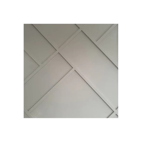 A light grey wall with a geometric pattern made from decorative strips arranged diagonally.
