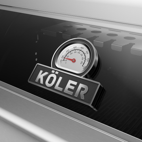 A dial thermometer with the Köler logo built into the glass lid of a gas barbecue.
