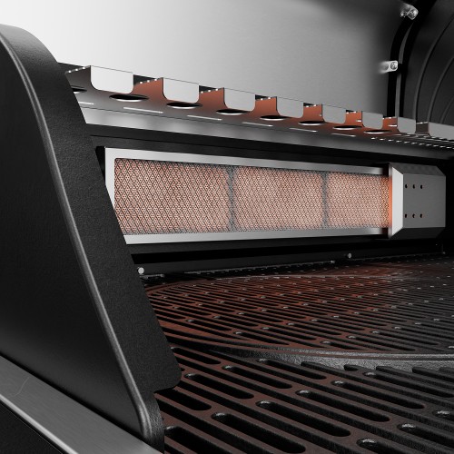 A heated ceramic infrared burner inside a gas barbecue, above a cast-iron grill grate.