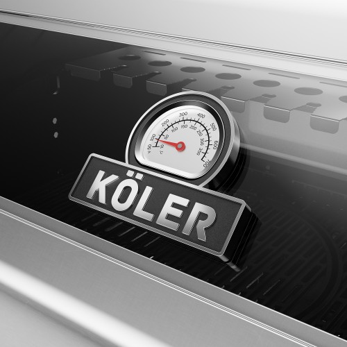 Built-in analogue thermometer and Köler logo on the glass lid of a gas barbecue.