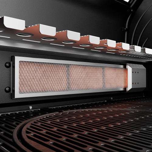 A glowing ceramic infrared burner in the cooking chamber of a Koler Krone S1 gas barbecue.