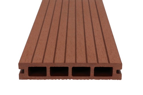 Cross-section of a brown composite decking board with 4 chambers and a grooved surface.