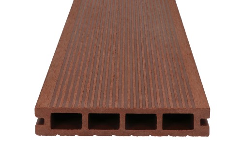 A grooved brown composite decking board, with a cross-section showing four chambers.